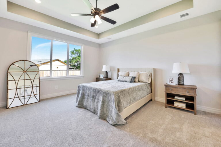 A master bedroom with a unique ceiling cutout