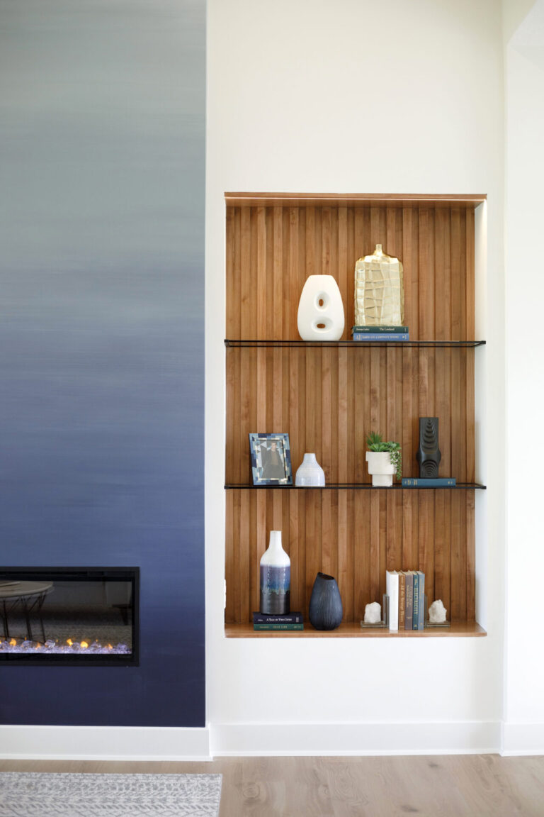 A wood cutout shelf next to a Socora fireplace